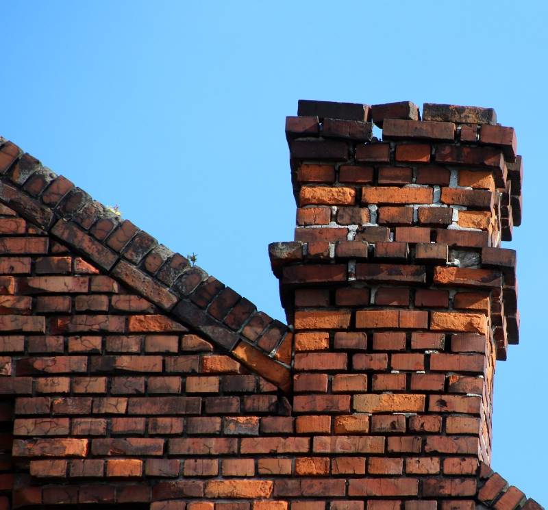 Damaged chimney on an Forney home showing cracks and missing mortar